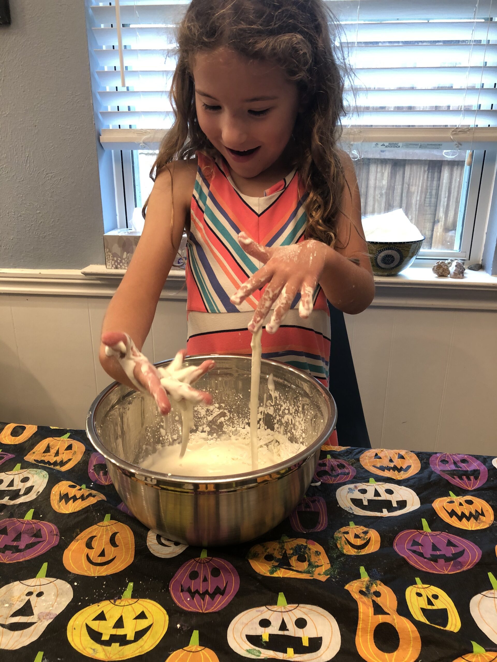 Child doing a science experiment- playing with oobleck